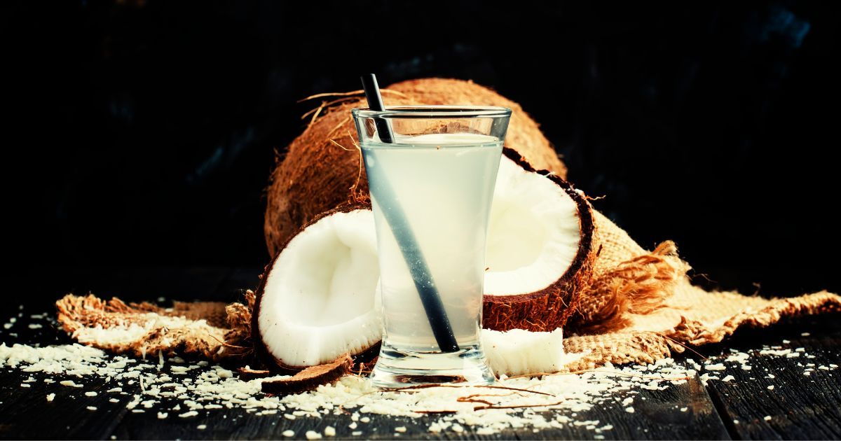 glass of coconut water and fresh coconuts