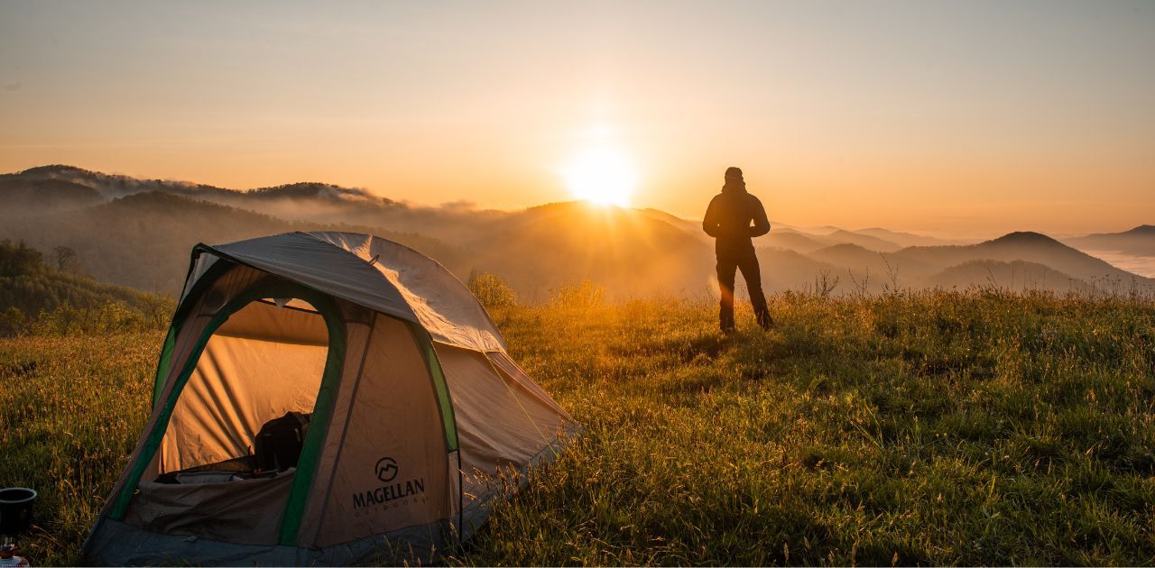 tent setup at sunset overlooking mountains