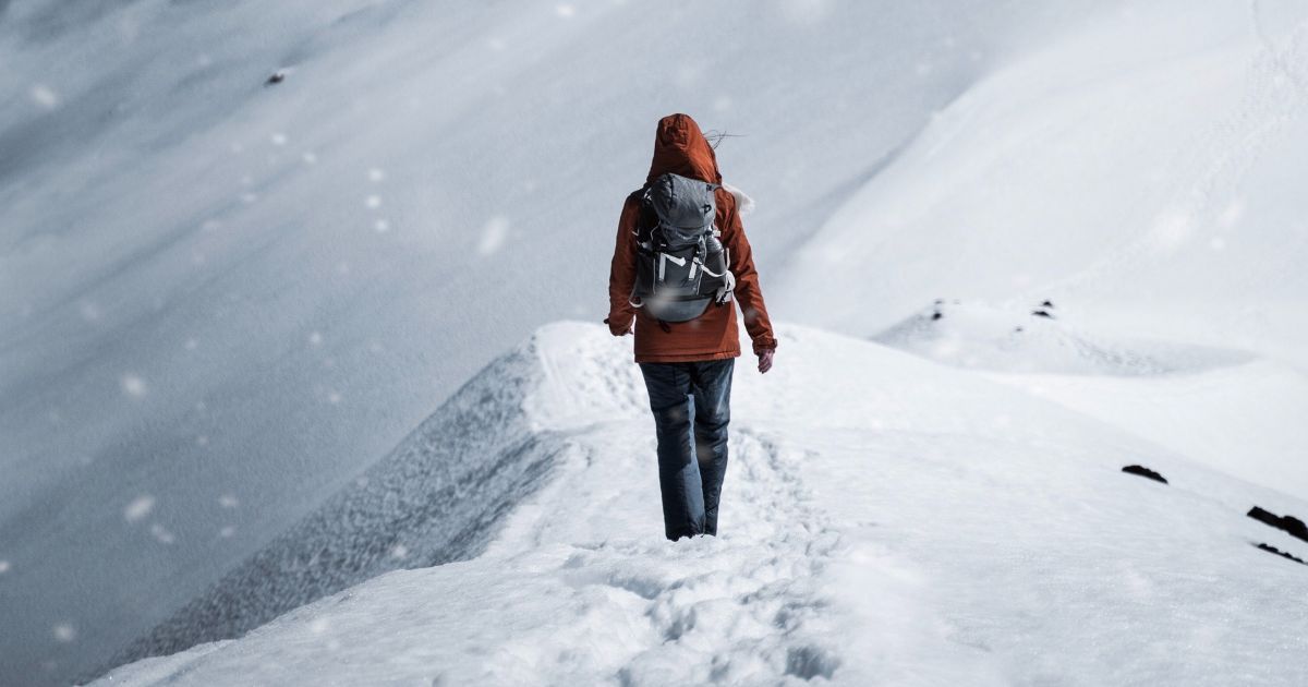 woman from behind walking in snow