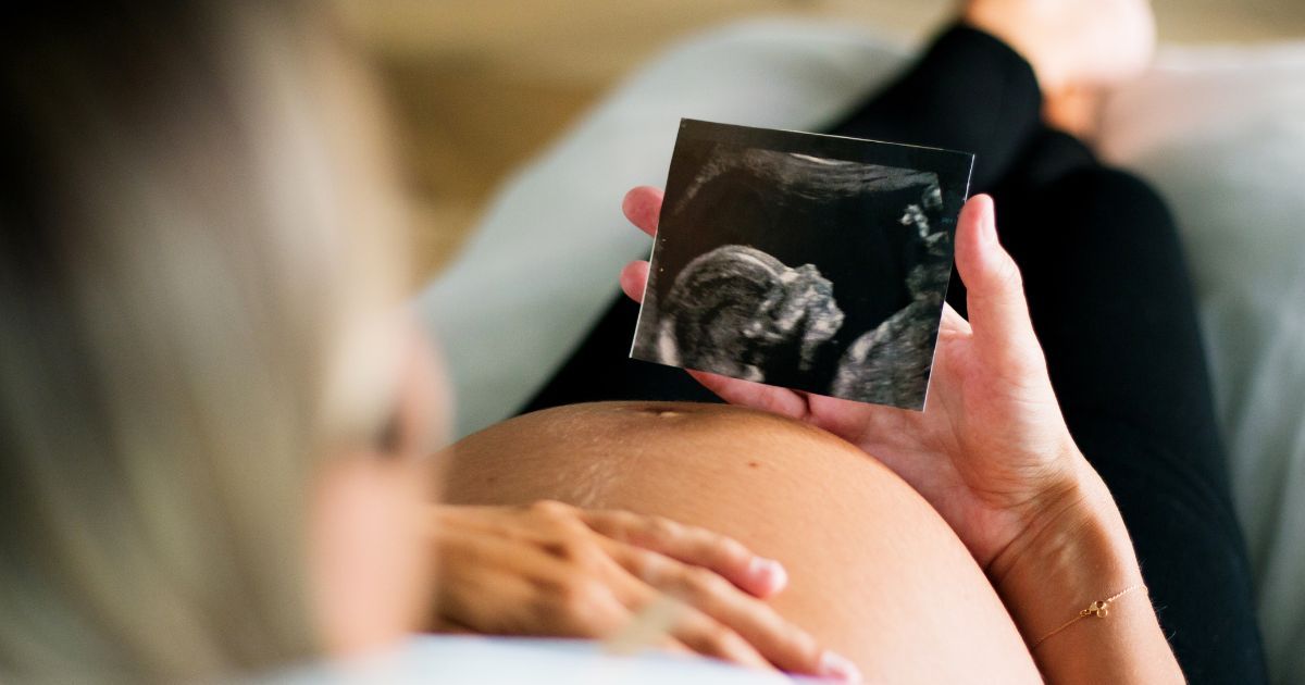 pregnant woman holding ultrasound