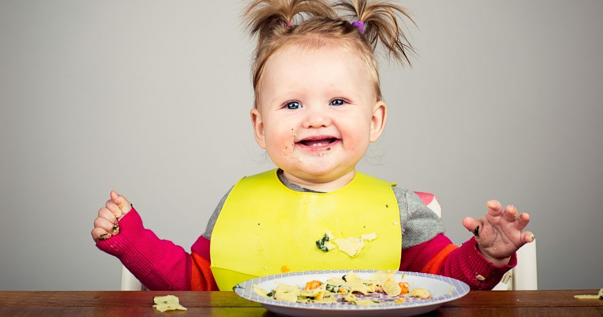 baby eating from plate