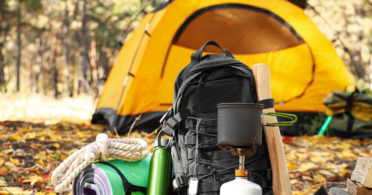 backpacking gear with tent in the background