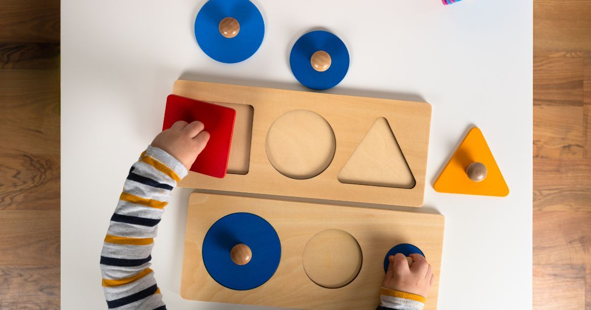 child playing with shapes puzzle