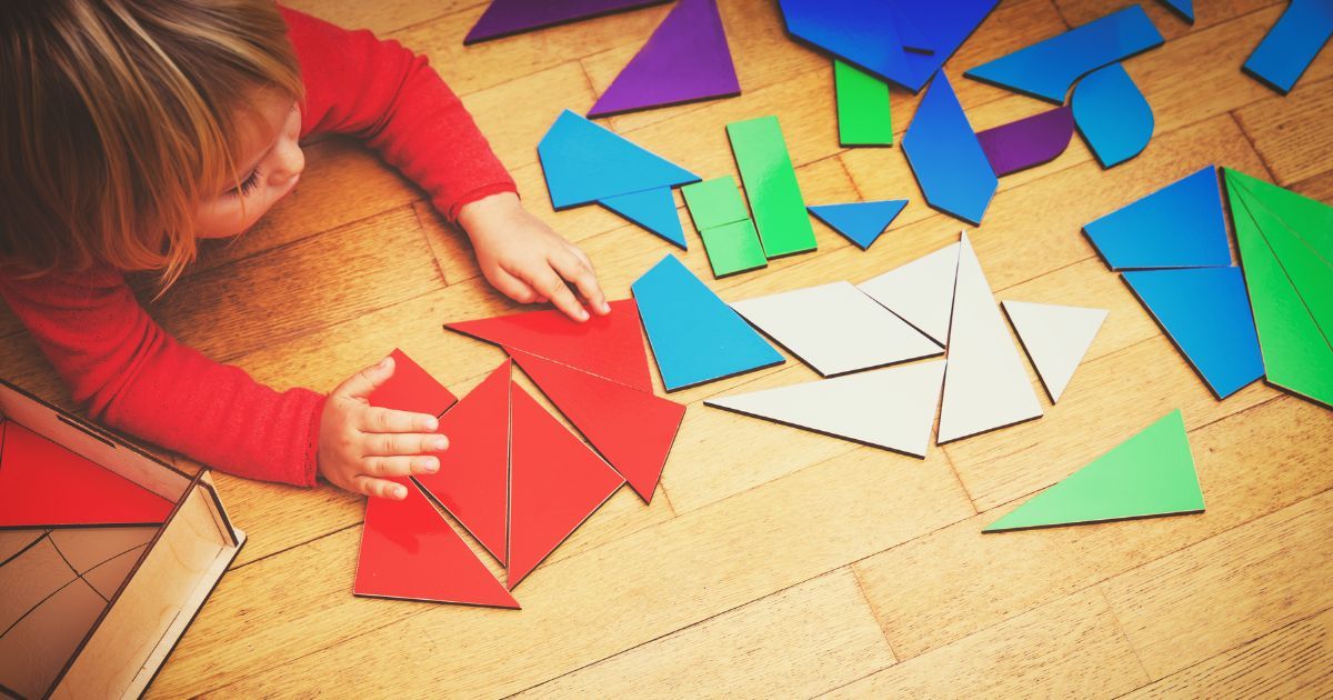 child playing with geometric puzzle