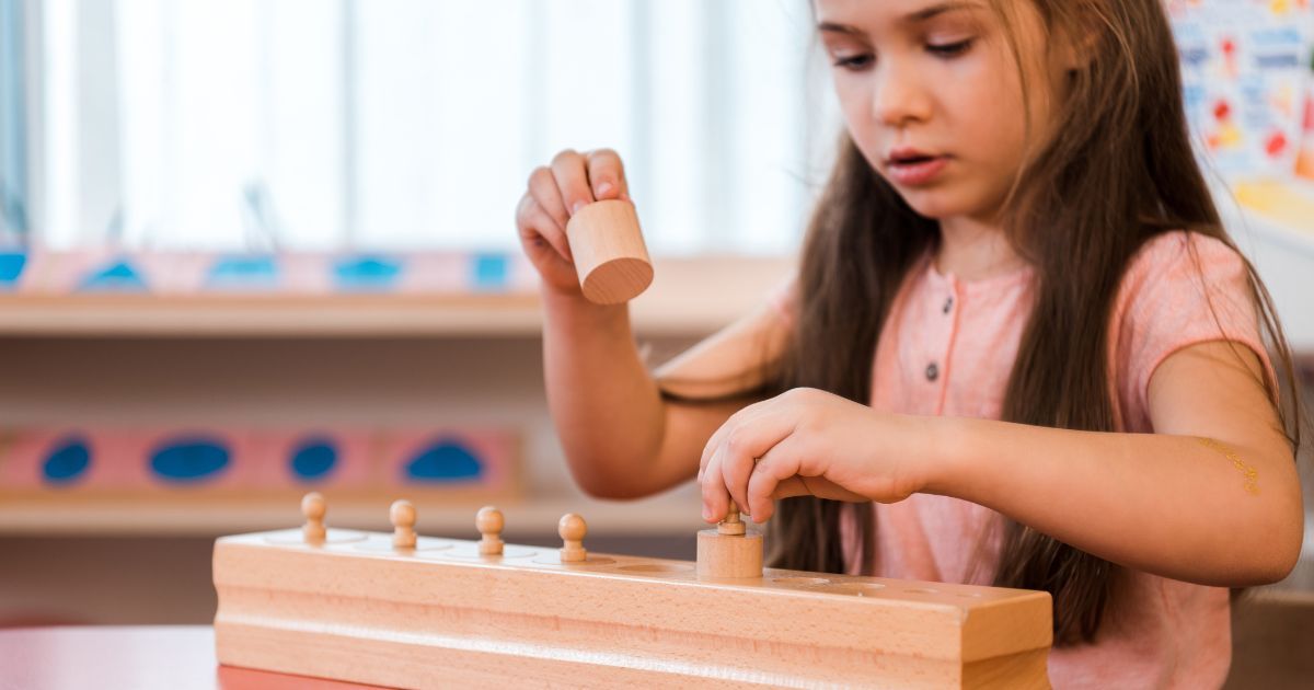 girl playing with wooden educational game