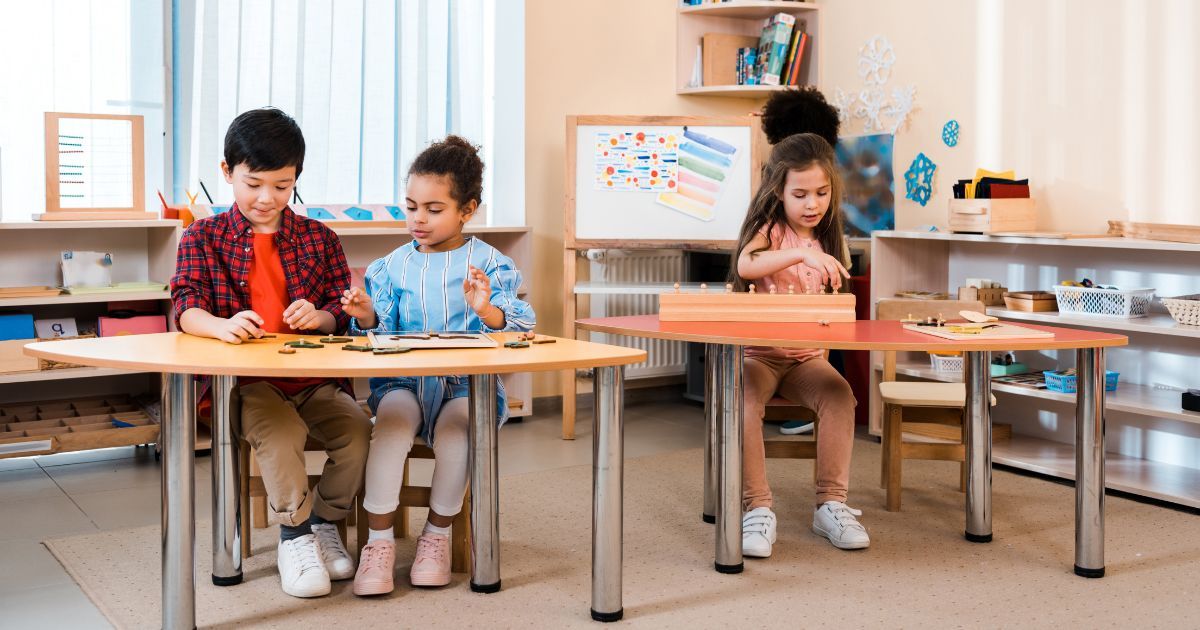 kids sitting and working independently in a Montessori classroom