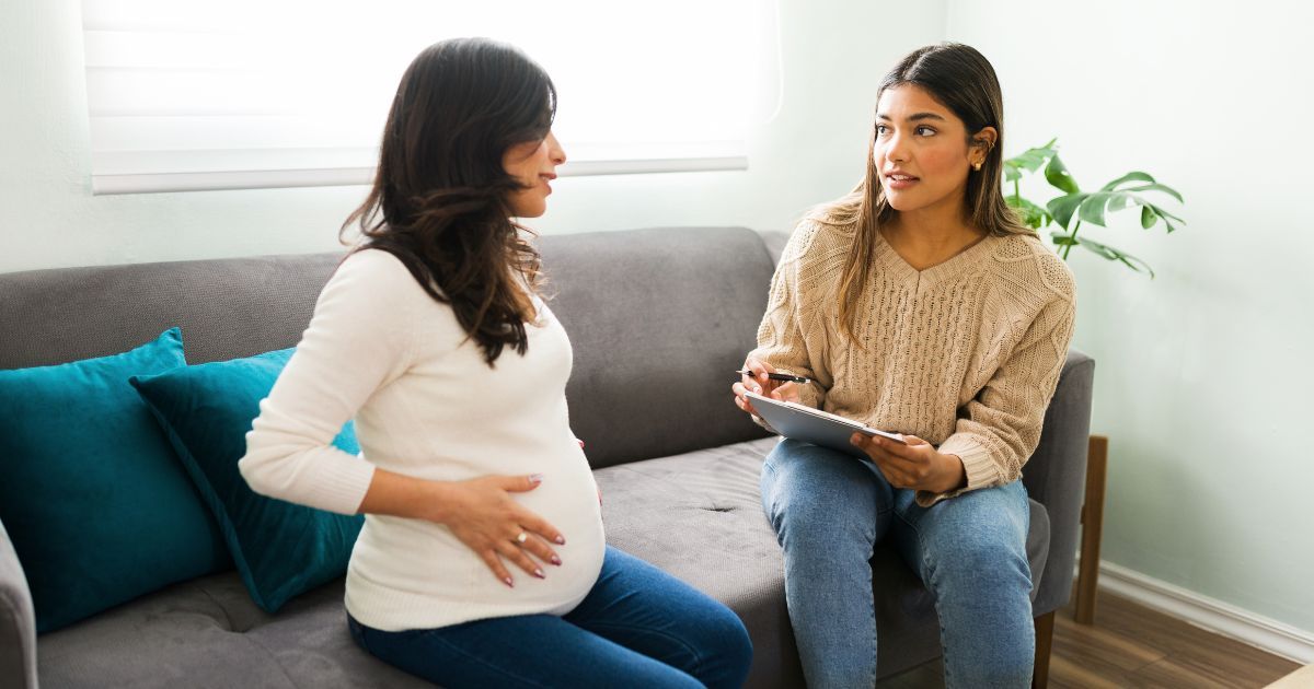 pregnant woman having a consultation with midwife
