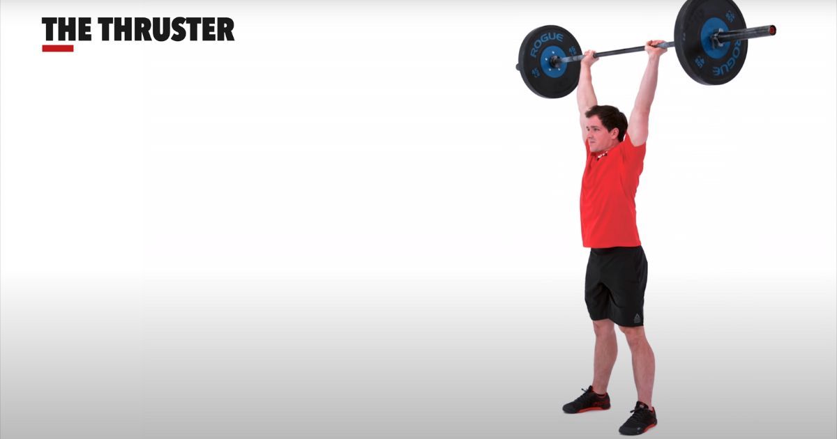 man in end position with weight overhead of thruster