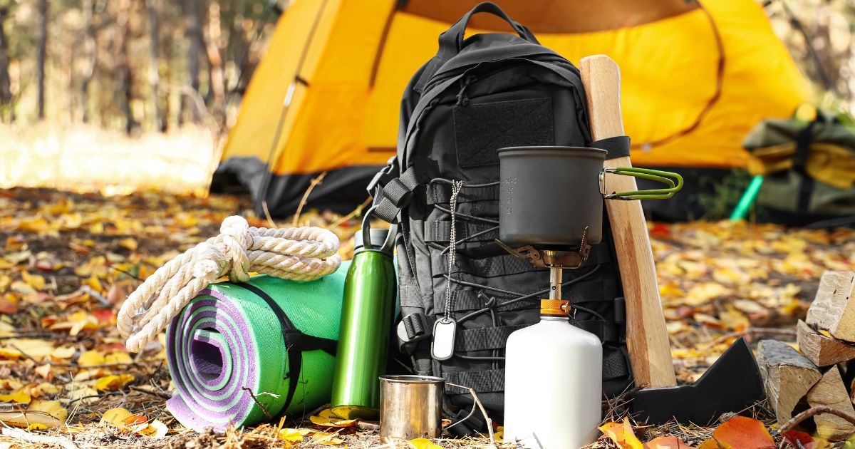 camping gear on ground with tent in background