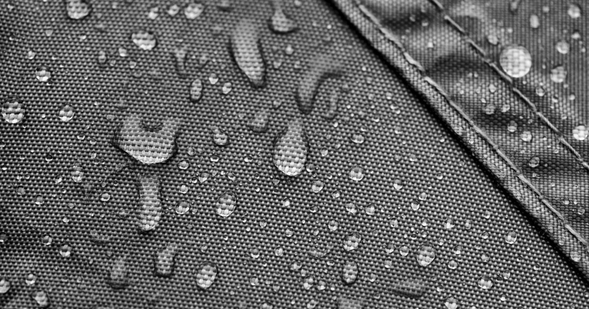 closeup of water on gray tent fabric