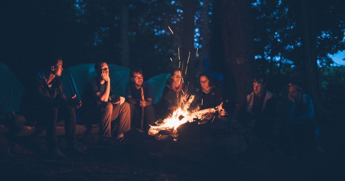 people around a campfire at night
