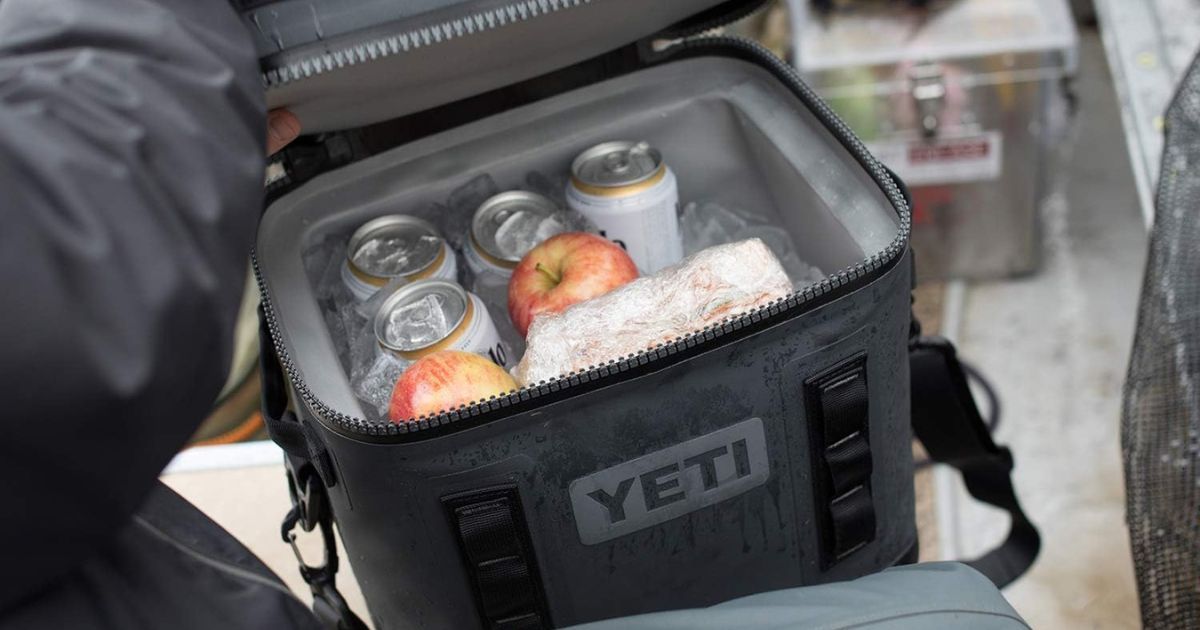 Yeti Hopper filled with cans, apple, sandwich, and ice