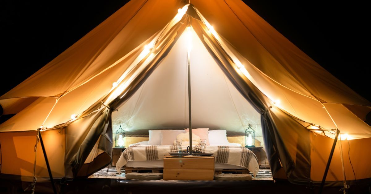 glamping tent bed at night