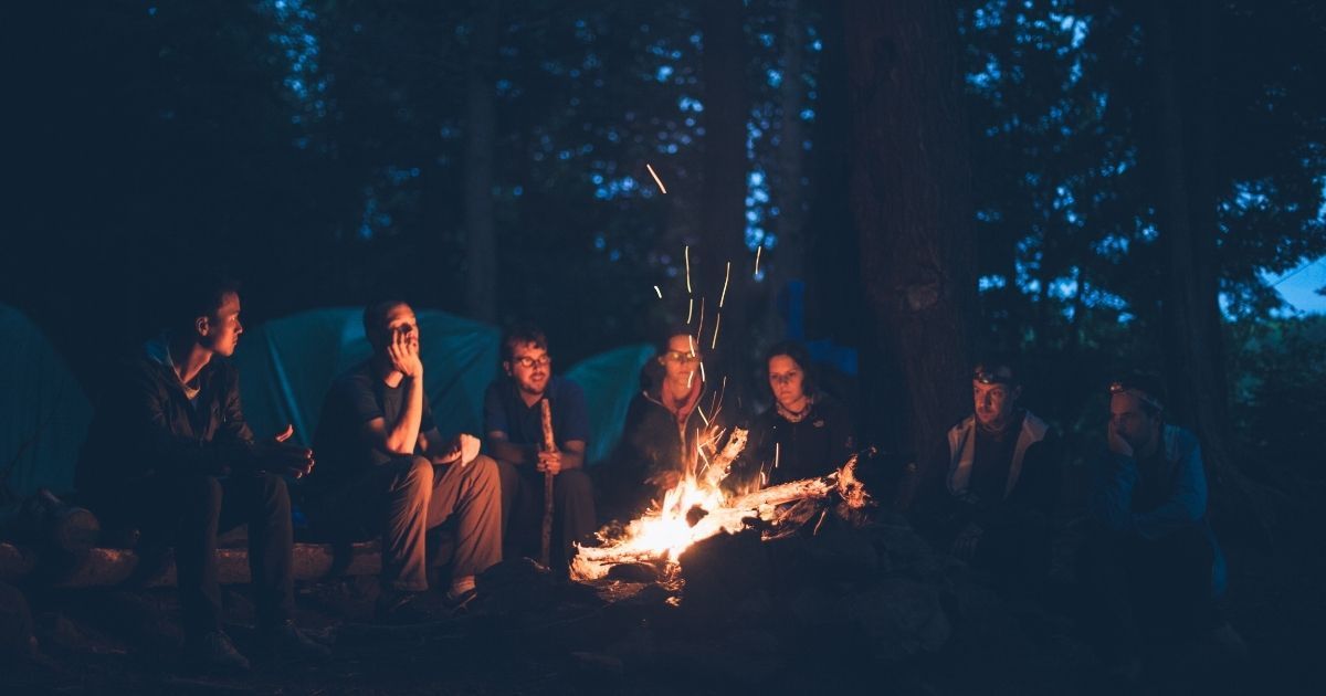 group of campers around fire