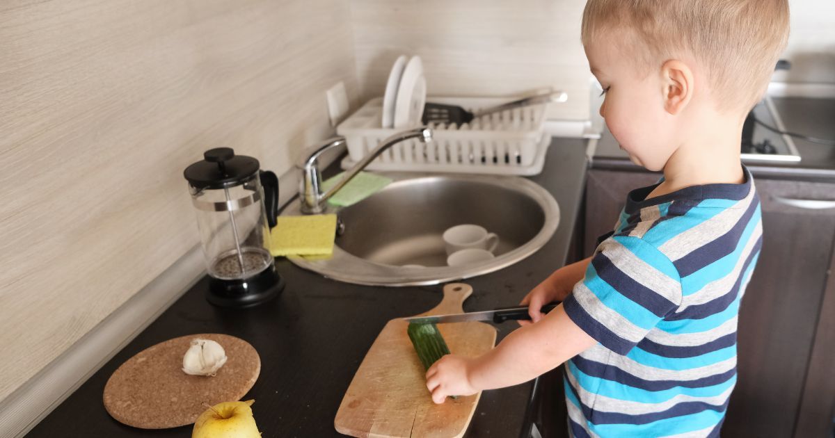 Montessori child cutting veggies