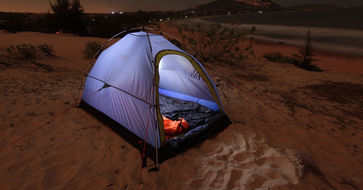 single wall tent setup on sand