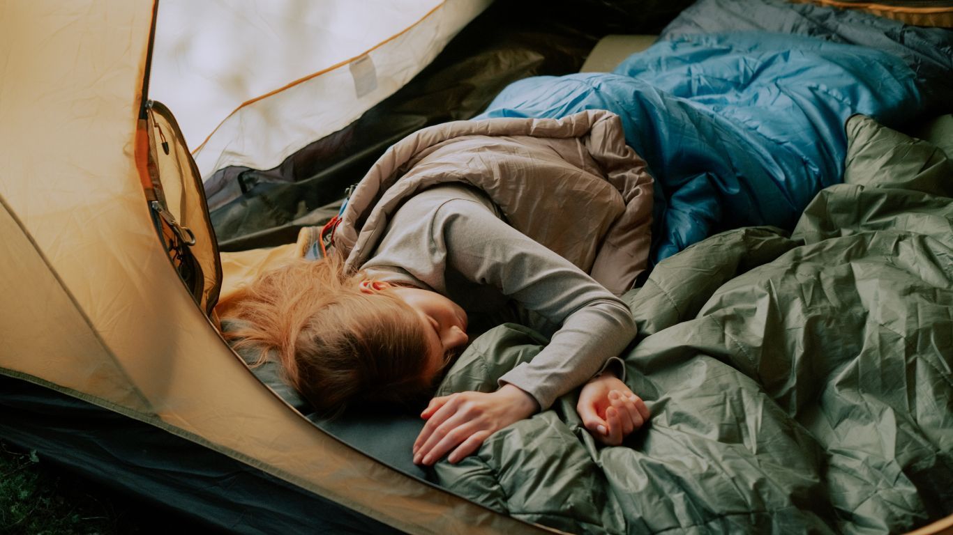 girl sleeping in tent