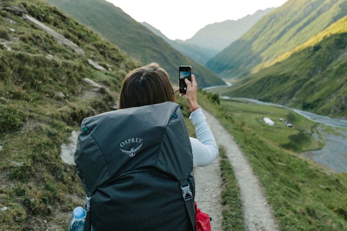 girl stopping to take a photo while backpacking