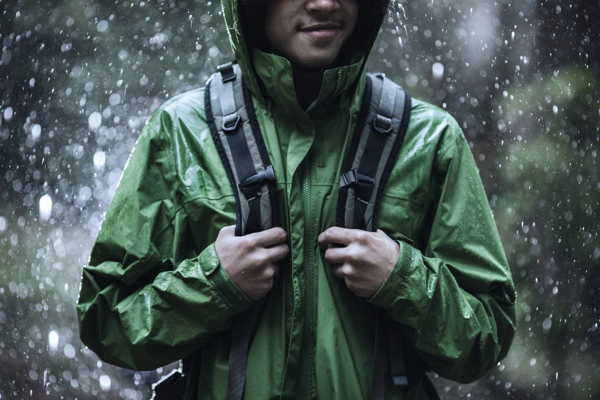 man hiking with rain jacket on