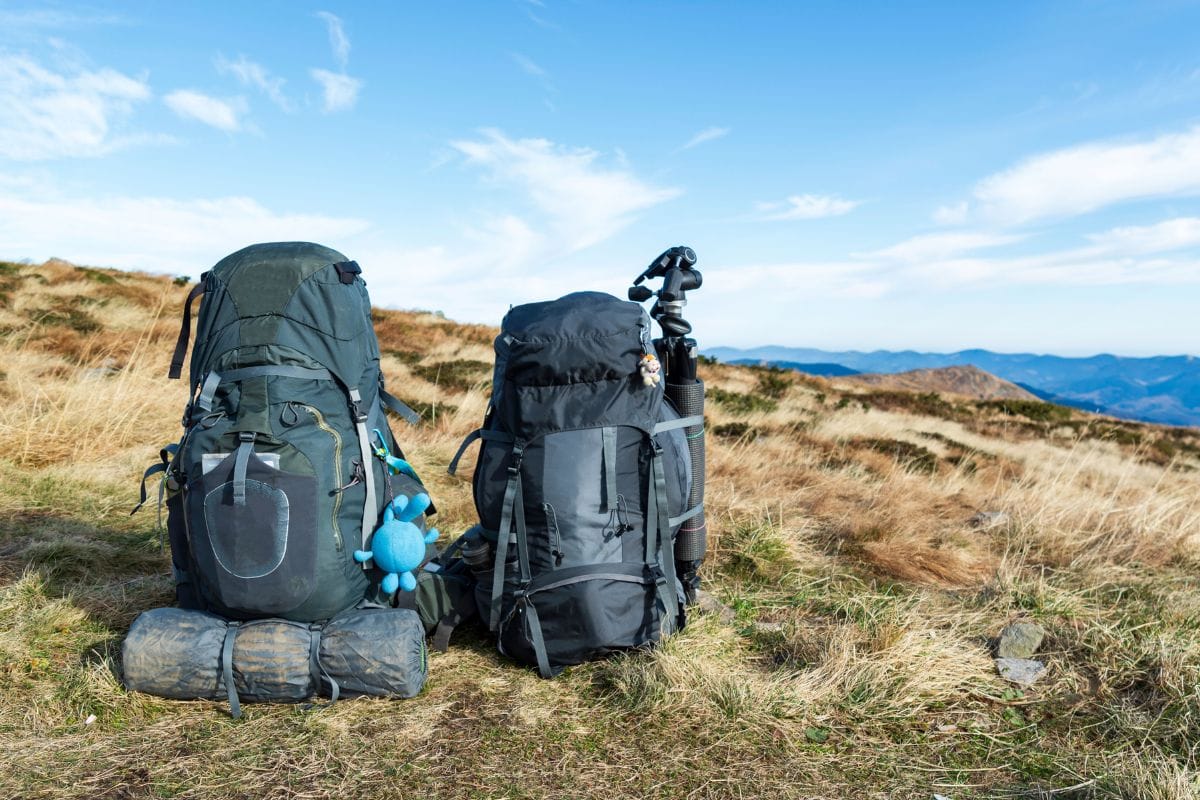 pair of hiking backpacks on the ground