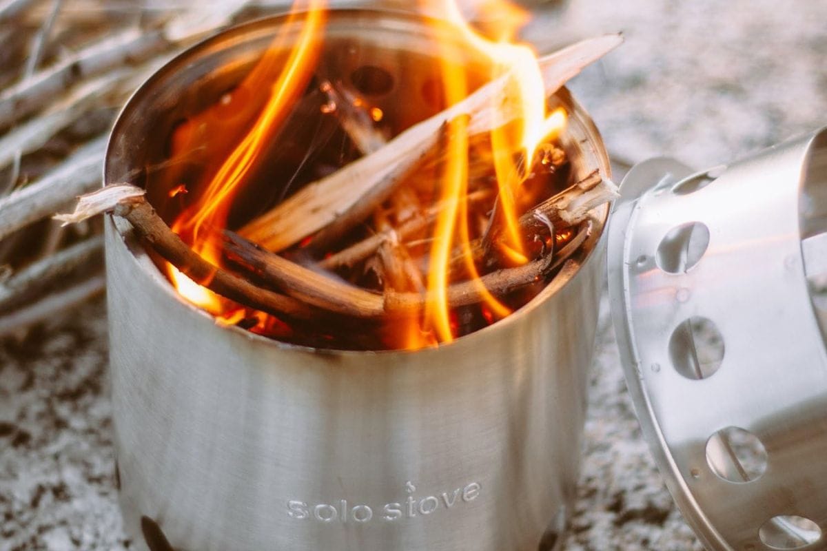close up of the solo stove lite with wood burning in it